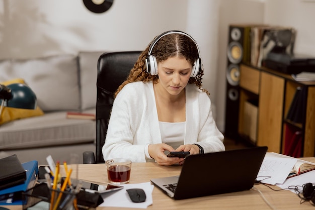 Beautiful attractive woman in wireless headphones in love with her boyfriend sitting at home