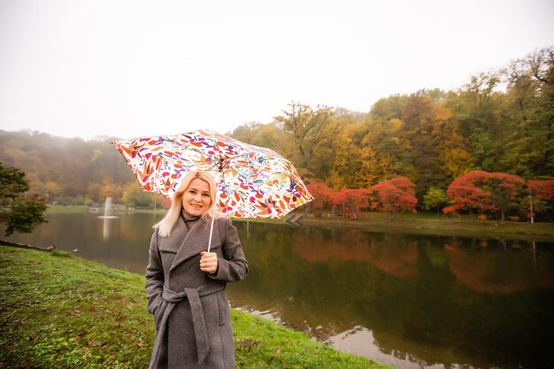 beautiful autumn park at fog weather