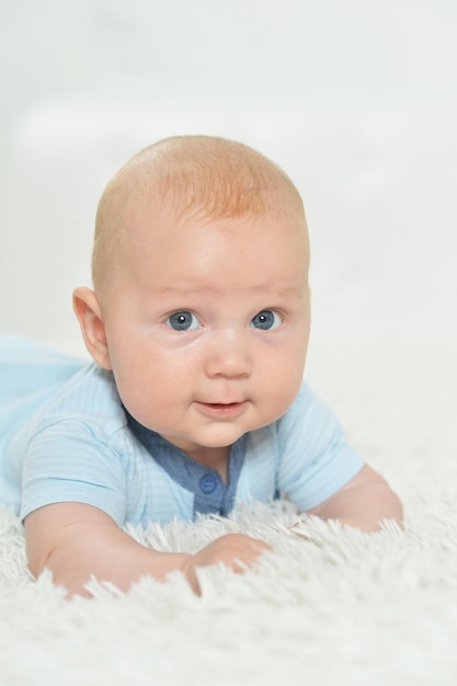 Beautiful baby boy on bed