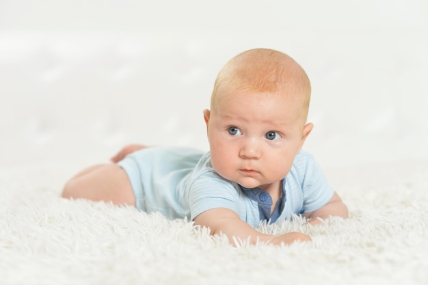 Beautiful baby boy on bed