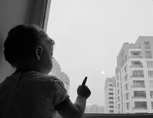 Beautiful baby boy with child face posing photographer near window for color photo cadre