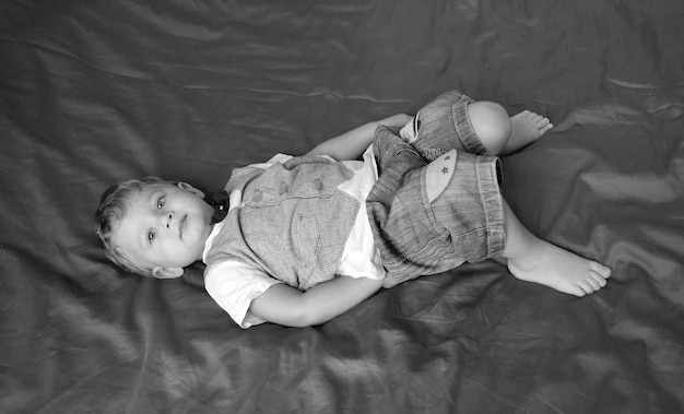 Beautiful baby boy with child face posing photographer