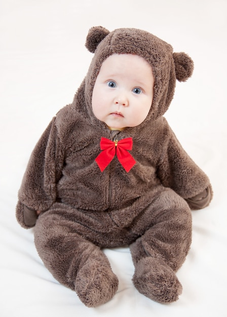 Beautiful baby in costume of bear