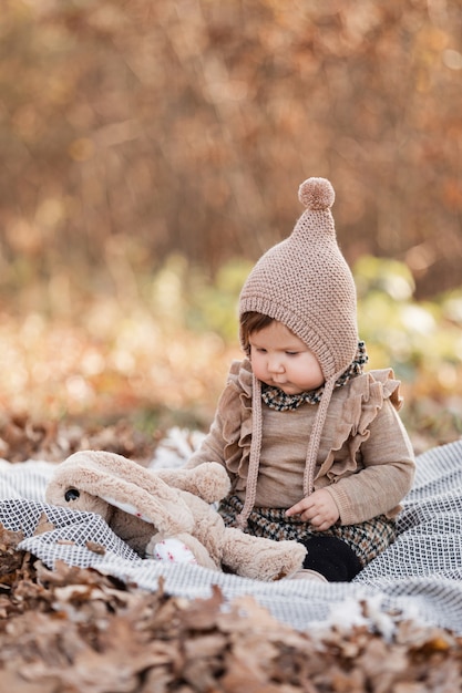 Beautiful baby girl sitting on the plaid