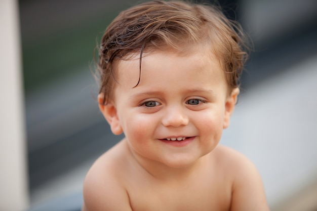 Beautiful baby outside with wet hair