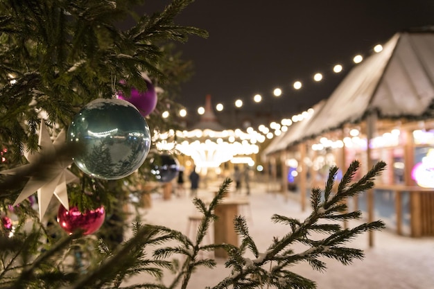 Beautiful background on Christmas Eve and New Year in St Petersburg Outdoor Christmas tree with a green ball closeup Winter holiday background