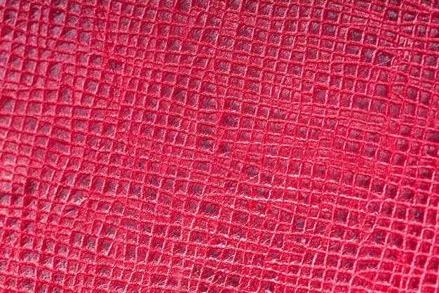 Beautiful background of red genuine leather. close-up. macros