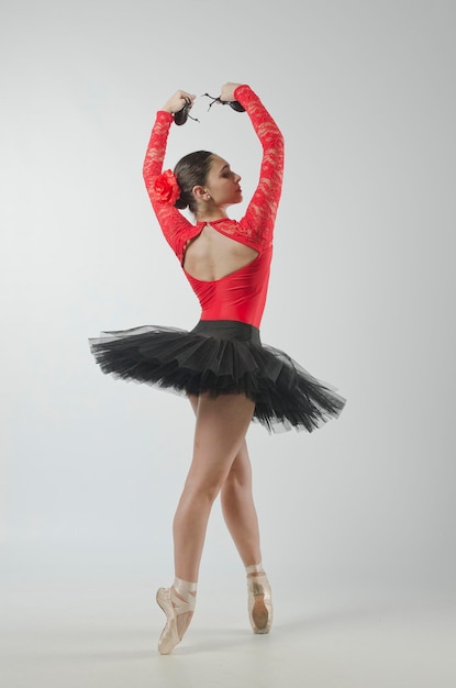 Beautiful ballerina dancing with black tutu and red body. she
danced on ballet pointe shoes.