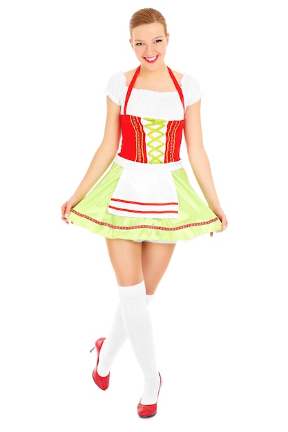 Photo a beautiful bavarian waitress posing over white background