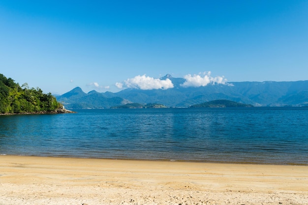 Beautiful beach in Angra do Reis green coast of Rio de Janeiro Tangua Beach Hills and mountains in the background on a sunny day Crystal clear water Dawn