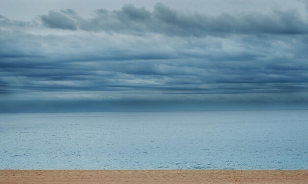 Beautiful beach landscape with calm water and cloudy sky