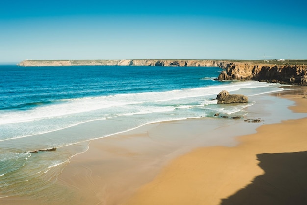 Beautiful beaches of fine sand and high slender cliffs one morning in the Algarve