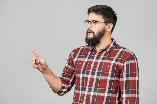 Beautiful bearded guy pointing aside