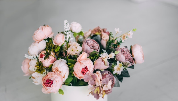 Beautiful beige purple violet pink flowers in white box