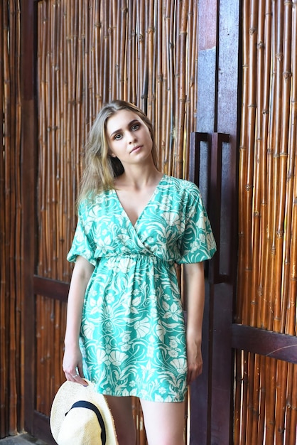 Beautiful Belarus woman in green dress with hat