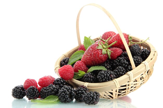 Beautiful berries with leaves in basket isolated on white