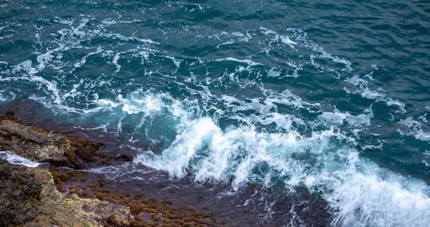 Belle grandi onde dell'oceano o del mare in estate colori azzurri blu brillante bellissimi pettini schiuma di mare bianca