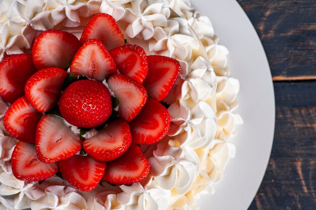 Beautiful birthday cake covered with chantillly and fresh strawberry. Top view