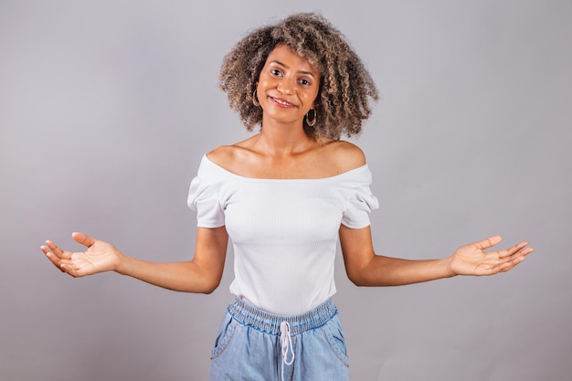 Beautiful black brazilian woman casual clothes fingers crossed arms open welcome Welcoming