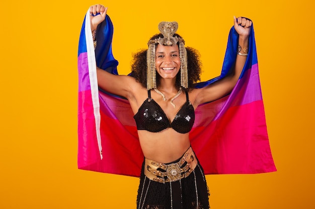 Beautiful black Brazilian woman in Cleopatra carnival clothes holding bisexual flag