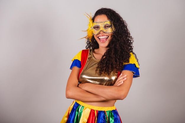 Beautiful black Brazilian woman with frevo clothes carnival Wearing a mask arms crossed