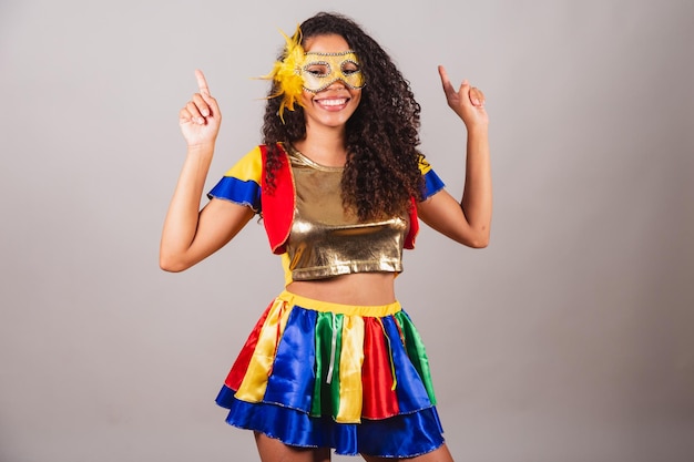 Beautiful black Brazilian woman with frevo clothes carnival Wearing a mask dancing to the carnival fanfare