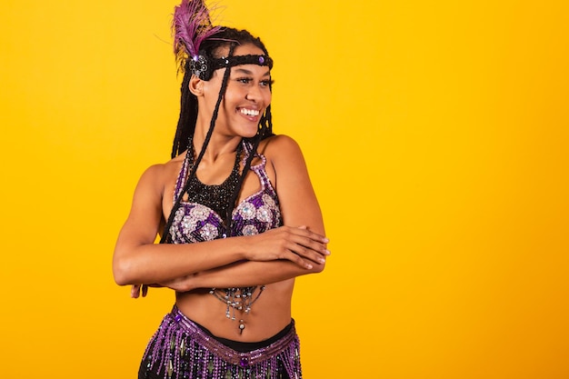 Beautiful black Brazilian woman with purple carnival clothes arms crossed