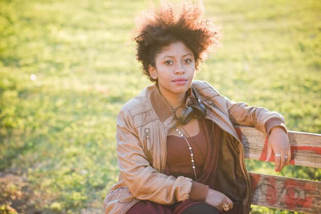 beautiful black curly hair african woman listening to music 