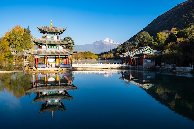 Beautiful of Black Dragon Pool with Jade Dragon Snow Mountain , landmark and popular spot for tourists attractions near Lijiang Old Town. Lijiang, Yunnan, China