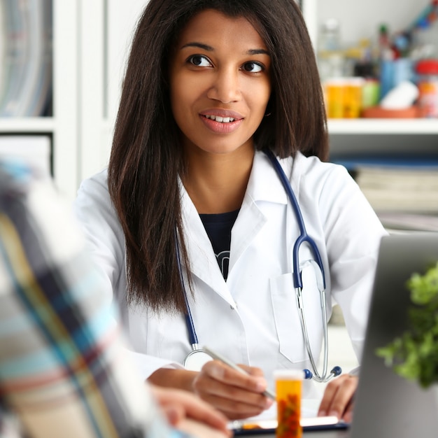 Beautiful black smiling female doctor talk with