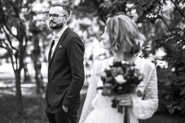 Beautiful black and white photo of bride and groom Happy couple posing and smiling in wedding dress