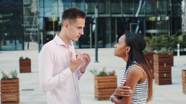 Beautiful black woman accusing her husband of treason outdoors