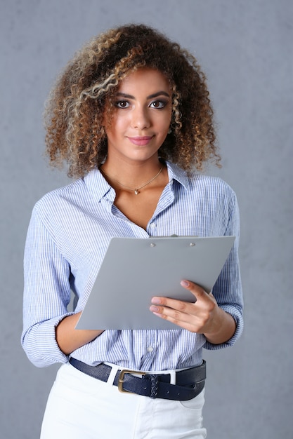 Beautiful black woman portrait. Holds a clipboard