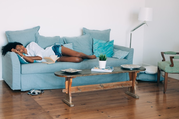 Beautiful black young woman sleeping in the sofa