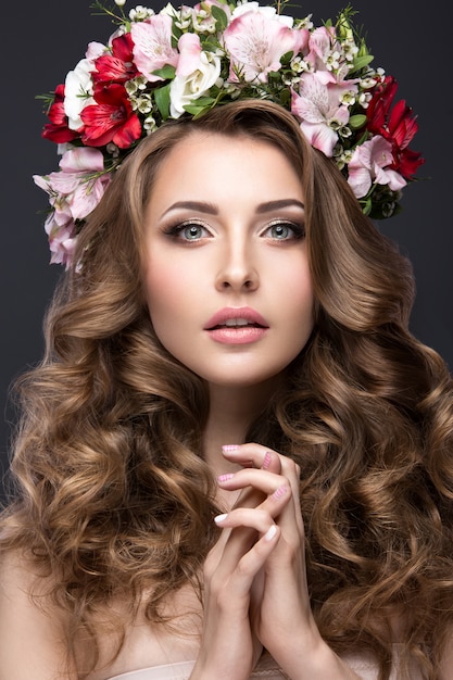 Beautiful blond girl in image of the bride with purple flowers on her head. 