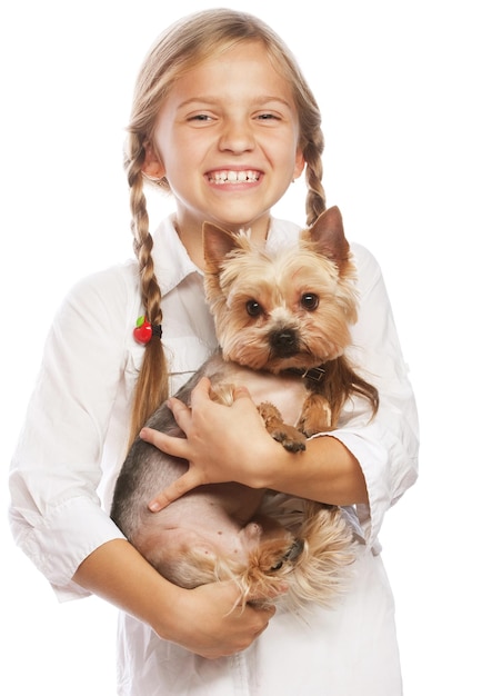Beautiful blond girl with cute yorkshire terrier dog isolated