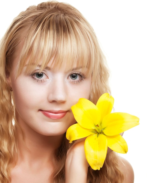 Beautiful blond girl with yellow lily