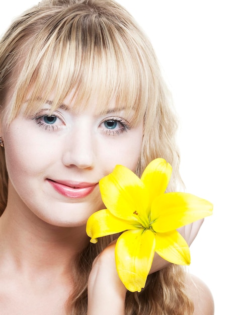 Beautiful blond girl with yellow lily