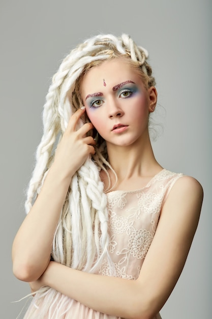 beautiful blond teenage girl with dreadlocks