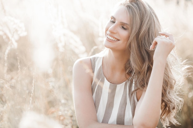 Beautiful blond woman closeup portrait outdoors Smiling face Lovely lady at summer background Emotional female outdoors