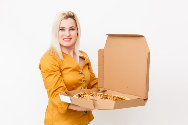 beautiful blond woman eatting piece of pizza