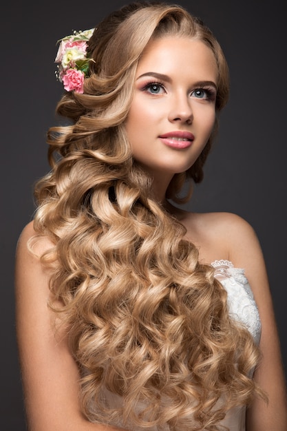 Beautiful blond woman in image of the bride with flowers. Beauty face and Hairstyle