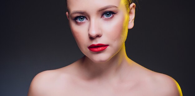 Beautiful blond woman portrait on black background.