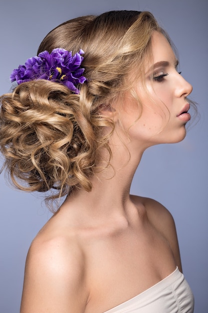 Beautiful blond woman with purple flowers on her head