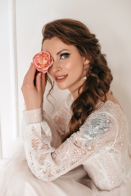 Beautiful blonde bride with bouquet of spring flowers outdoor.