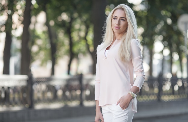 Beautiful blonde businesswoman on the city streets