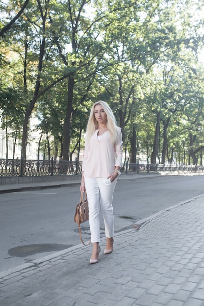 Beautiful blonde businesswoman on the city streets