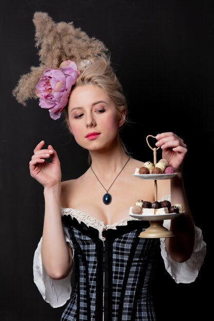 Foto bella contessa bionda con caramelle al cioccolato