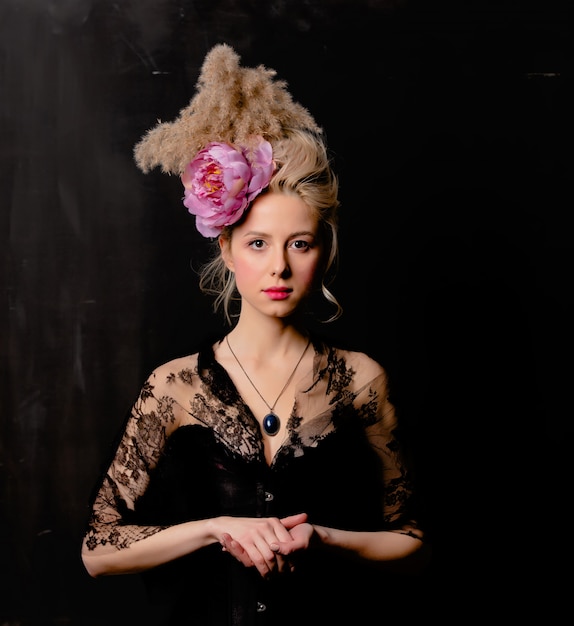 Beautiful blonde countess with vintage hairstyle and corset