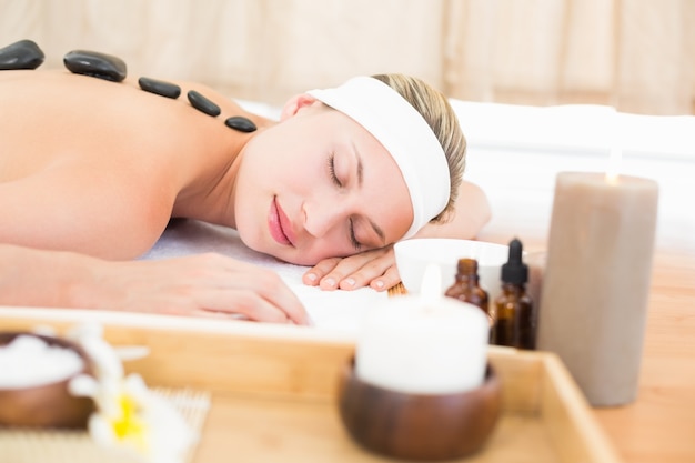 Beautiful blonde enjoying a hot stone massage 